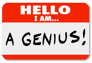 A red nametag with the words Hello I Am A Genius that might be worn by a brilliant expert or very smart person, or someone who is a braggart and blowhard who thinks highly of him or herself